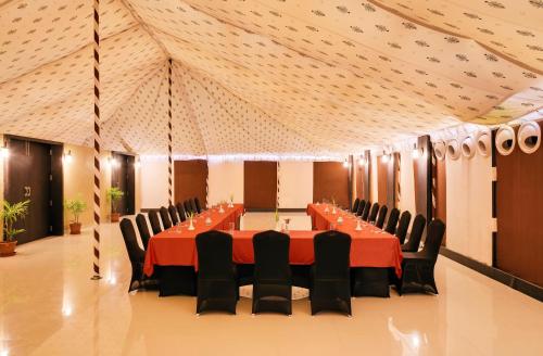 a banquet hall with a long table and chairs at Sterling Kanha in Kānha