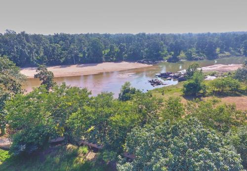 an aerial view of a river with trees at Sterling Kanha in Kānha