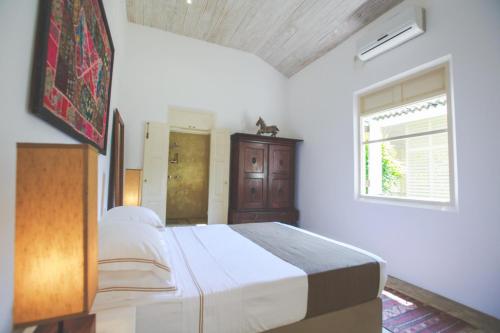 a bedroom with a large bed and a window at Karmel Villa Thalduwa Island - Five Bedroom Luxury Villa with Private Pool in Ahangama