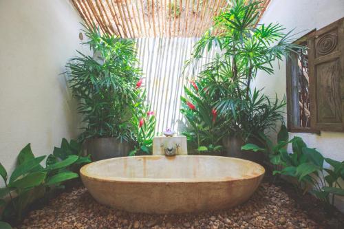 a large tub in a room with plants at Karmel Villa Thalduwa Island - Five Bedroom Luxury Villa with Private Pool in Ahangama