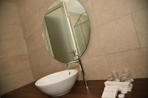 a bathroom with a sink and a mirror at Casa Bonita Hotel in Melaka
