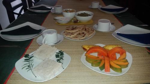 a table with plates of food on top of it at Bon Accord Mirissa in Mirissa