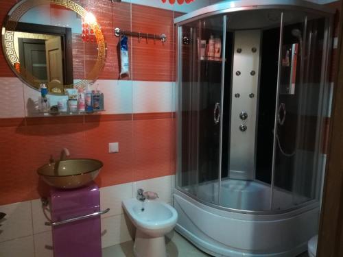 a bathroom with a shower and a toilet and a sink at Apartment Haradsky Val 9 in Minsk