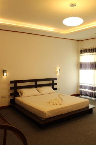 a bedroom with a large bed in a room at Nico Lagoon Hotel in Negombo