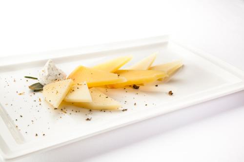 a plate of cheese on a white plate at Hotel Lungomare Opatija - Liburnia in Opatija