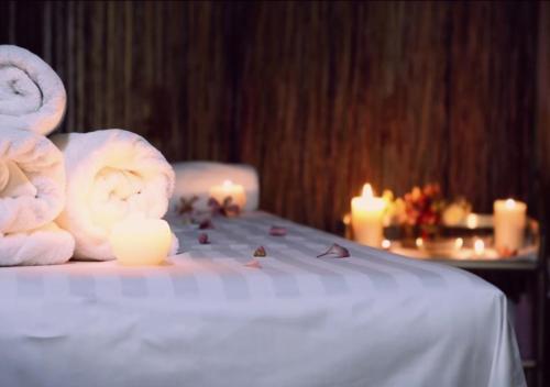 a room with candles and towels on a bed at Cron Palace kosher Tbilisi Hotel in Tbilisi City