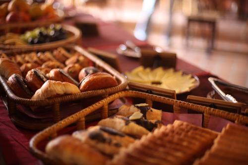 a table topped with baskets of bread and pastries at Kantipur Temple House in Kathmandu