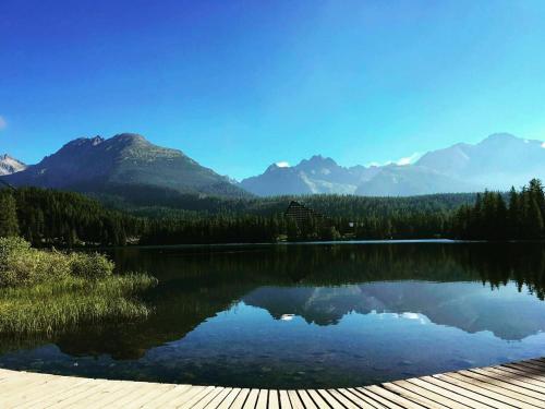 a view of a lake with mountains in the background at Apartman Deluxe Štrbské Pleso in Štrbské Pleso