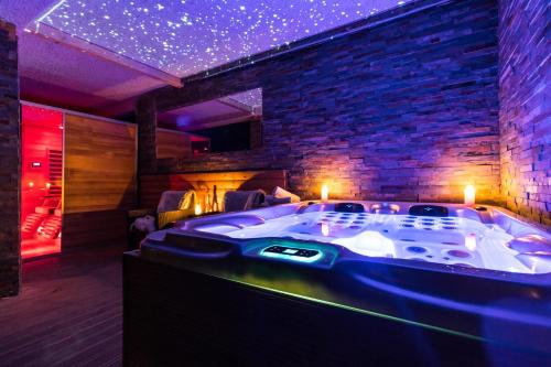 a jacuzzi tub in a room with a brick wall at Boutique penzion Rech in Blansko