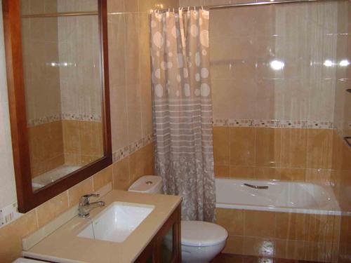 a bathroom with a sink and a toilet and a shower at Stone Cottage FINISTERRE in Curtis