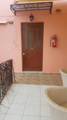 a front door of a house with a brown door at Studio Lefaki in Rethymno Town