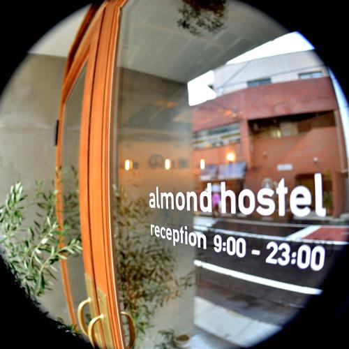 a close up of a window with the words abnormal hospital at almond hostel & cafe Shibuya in Tokyo