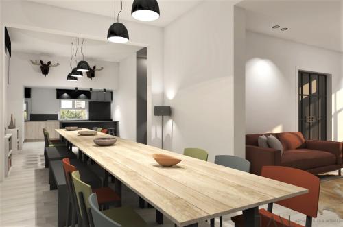 a kitchen and dining room with a wooden table and chairs at De Pastorie in Middelkerke