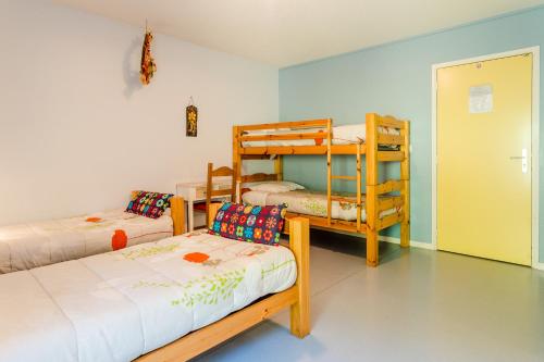 a room with two bunk beds and a couch at gite de pontgibaud in Lathuile