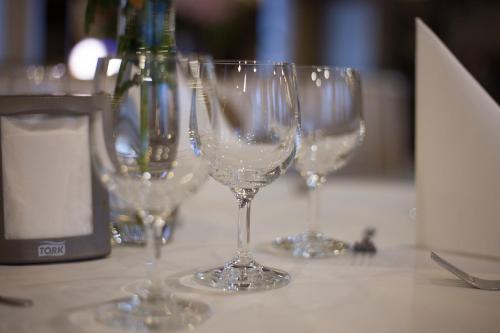 a group of wine glasses sitting on a table at euroHOTEL Katowice Nikiszowiec in Katowice