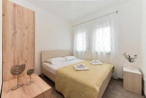 a bedroom with a bed with two towels on it at Crowonder Luxury Vir- 6 New Apartments for Families with Playground for Kids in Vir