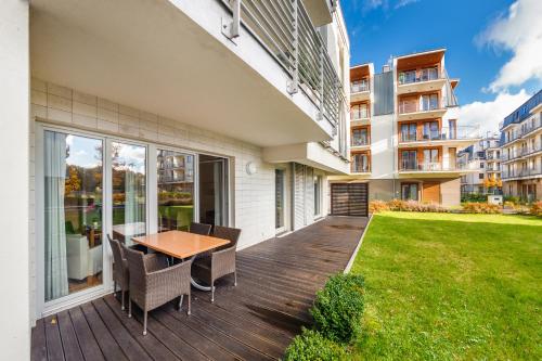 a wooden deck with a table and chairs on a building at Casa Marina, Sun & Snow in Świnoujście