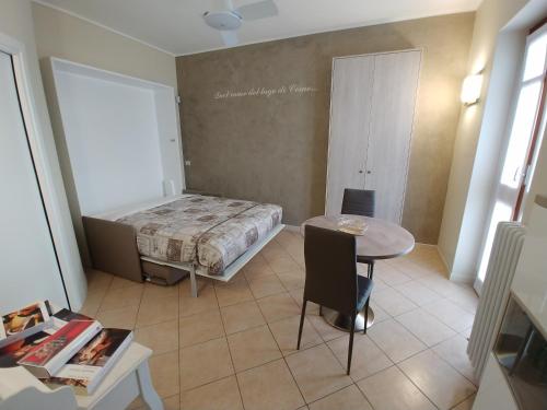 a small room with a bed and a table at La Finestra Sul Lago in Cernobbio