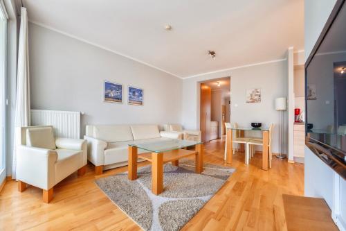 a living room with a couch and a table at Casa Marina, Sun & Snow in Świnoujście