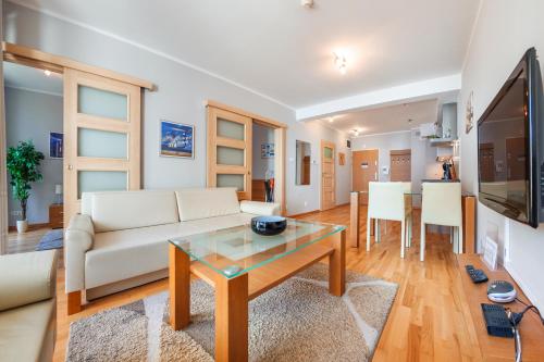 a living room with a couch and a table at Casa Marina, Sun & Snow in Świnoujście