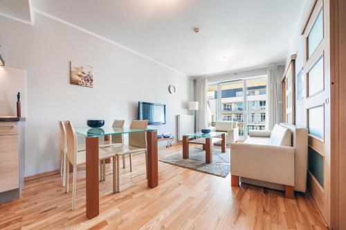 a living room with a table and a dining room at Casa Marina, Sun & Snow in Świnoujście