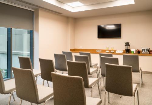 a waiting room with chairs and a flat screen tv at Park Inn by Radisson Istanbul Atasehir in Istanbul
