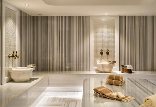 a bathroom with two sinks and a tub and two toilets at Park Inn by Radisson Istanbul Atasehir in Istanbul