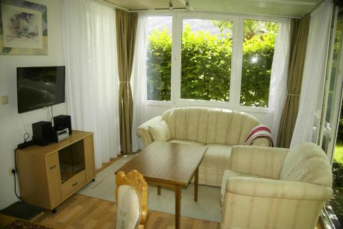 a living room with two chairs and a table at Gästehaus Gaisalpe in Fischen
