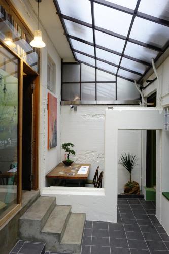 a room with a table and a glass ceiling at Cao Ji Book Inn Hostel in Tainan