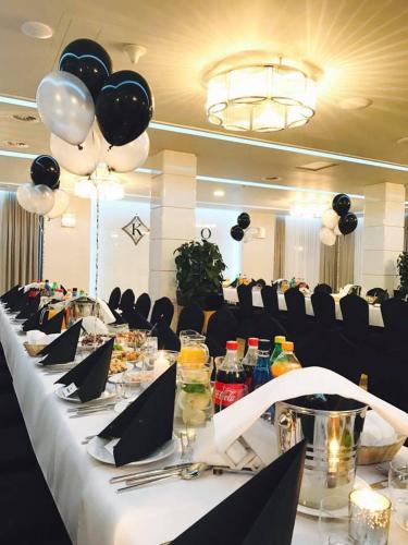 a long table with food and balloons on it at Hotel KARO in Radom
