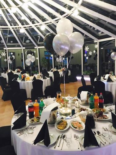a dining table with plates of food and balloons at Hotel KARO in Radom