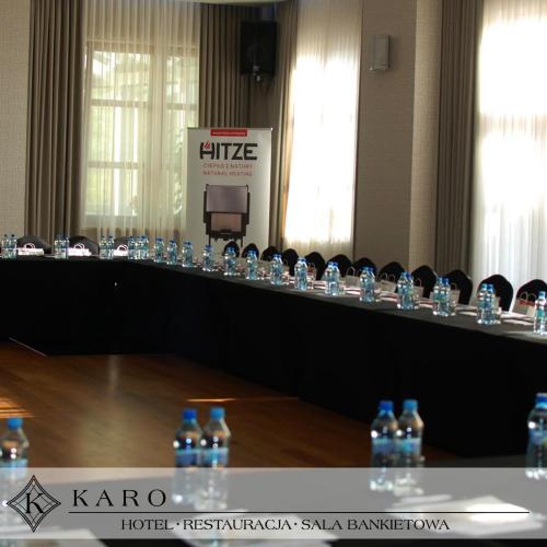 a row of bottles of water on a table at Hotel KARO in Radom