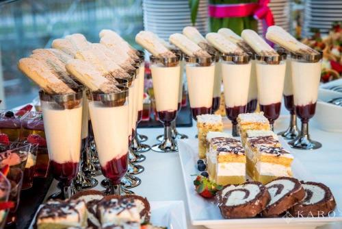 a buffet of desserts and drinks on a table at Hotel KARO in Radom