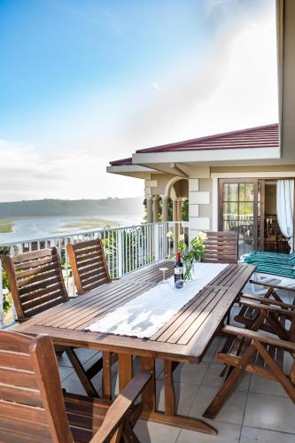 a wooden table on the deck of a house at Moncrieff Manor in Knysna