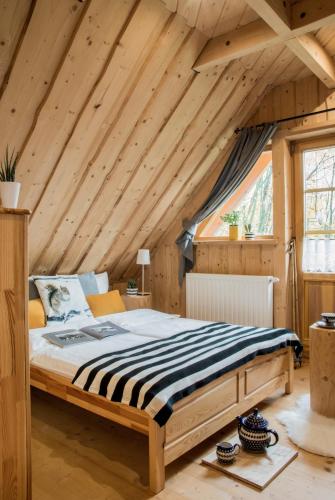 a bed in a room with a wooden ceiling at Klimkówka in Zakopane