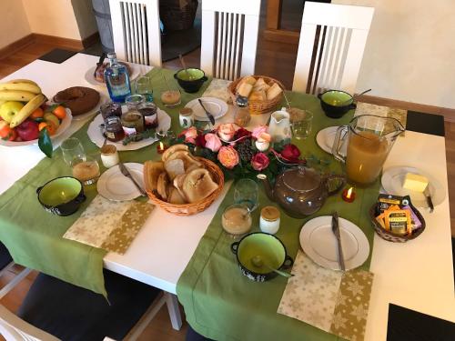 a table with a green table cloth with food on it at Chez Dina in Lutzelhouse