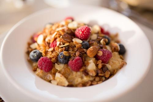 a bowl of cereal with berries and nuts on a plate at Number 31 in Dublin