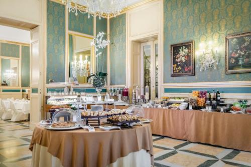 a room with two tables with food in it at Eurostars Centrale Palace Hotel in Palermo