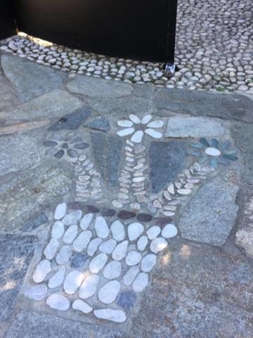 a painting of a cross on a stone sidewalk at Casa Cuniolo Guest House in Tortona