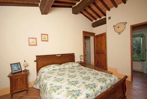 a bedroom with a bed in a room at Villa il Pino by VacaVilla in Lari