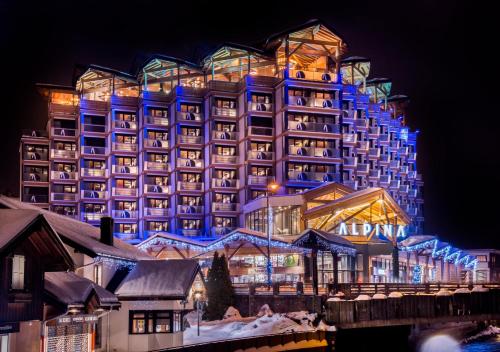 a large building with blue lights in front of it at Alpina Eclectic Hotel in Chamonix-Mont-Blanc