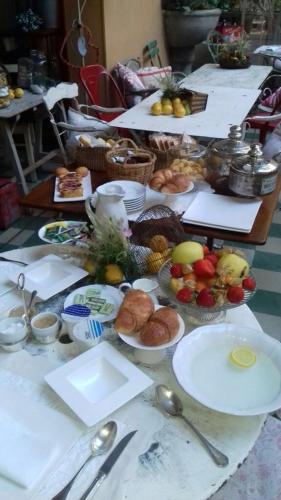 a long table with plates of food on it at Albergo Residence Perosi in Tortona