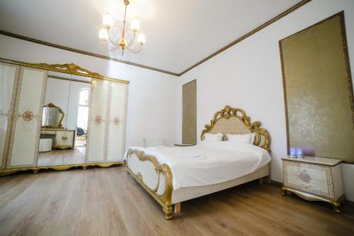 a bedroom with a large bed and a mirror at Castelul Cantacuzino in Buşteni