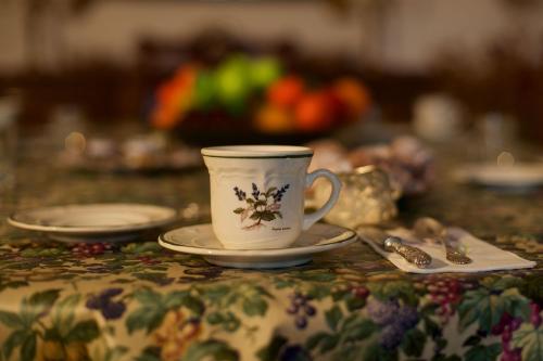 a coffee cup and saucer on a table at Palazzo Pulieri in Altino