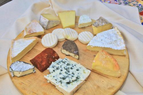 a plate of different types of cheese on a table at Logis Auberge La Diege in Capdenac-Gare