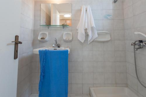 a bathroom with a sink and a tub and a toilet at Helen & Theo Studios in Laganas