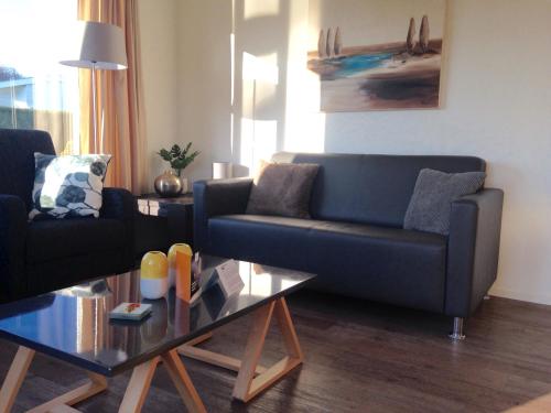 a living room with a couch and a table at Holiday rentals in Velsen-Zuid