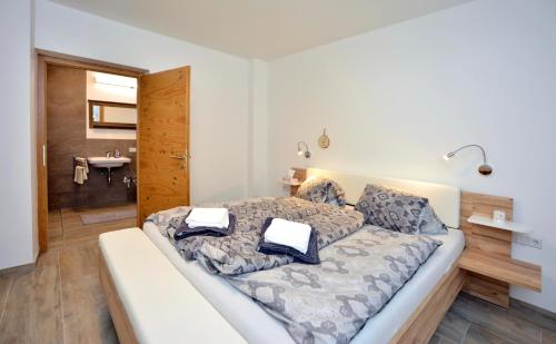 a bedroom with a bed with two pillows on it at Landhaus Antonia in Seefeld in Tirol
