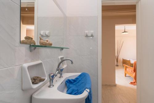 a bathroom with a sink and a mirror at Helen & Theo Studios in Laganas