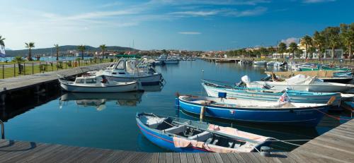 a group of boats docked in a harbor at Gabbiano Azzurro Hotel & Suites in Golfo Aranci
